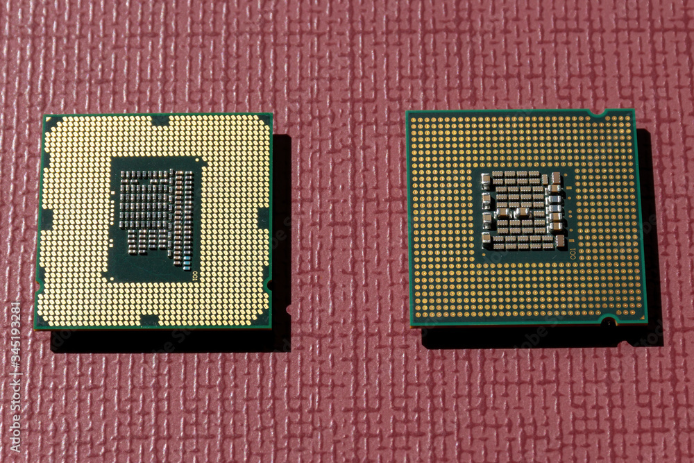 Two different model computer processors gold plate side view Two different model computer processors gold plate side view