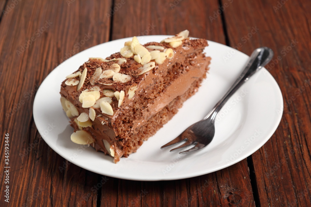 Chocolate sandwich cake garnished with flaked almonds Chocolate sandwich cake garnished with flaked almonds