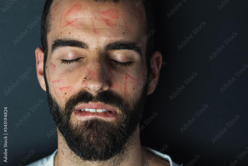 Bearded man with traces of lipstick on his face Bearded man with traces of lipstick on his face