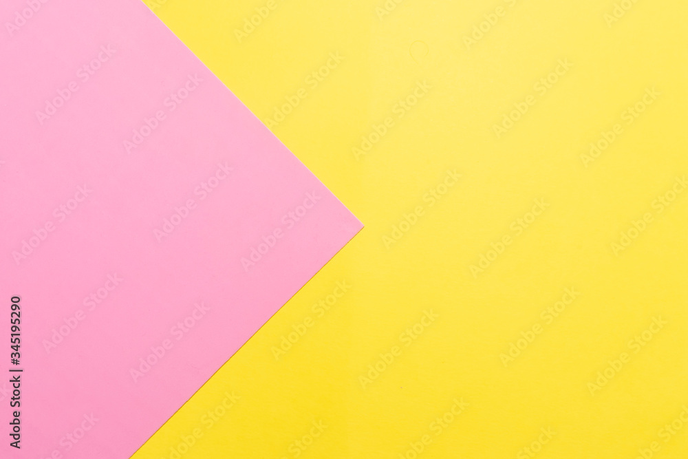 Pink and yellow two colours paper geometrical triangular background. Pink triangle on yellow background Pink and yellow two colours paper geometrical triangular background. Pink triangle on yellow background