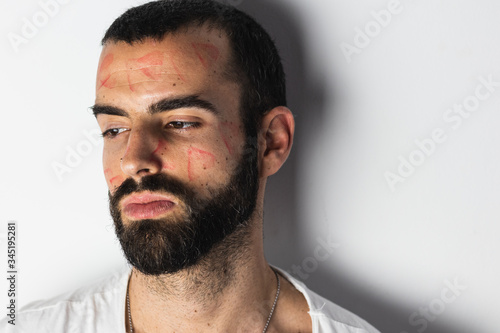 Bearded man with traces of lipstick on his face