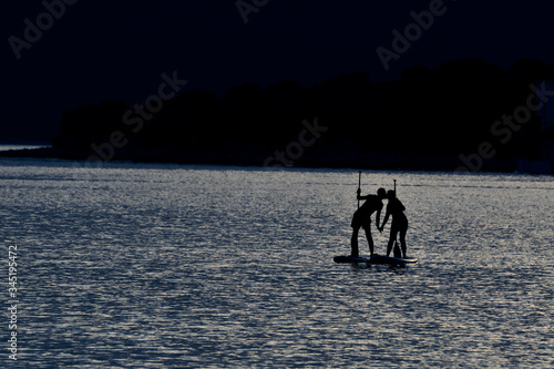 Kiss during sup paddling on moonlight
