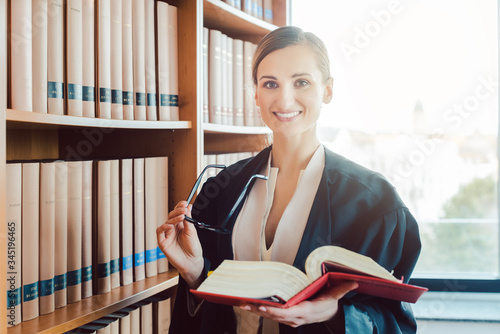 Lawyer working on a difficult case reading in the library photo