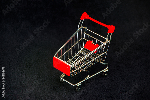 supermarket shopping cart on black background.