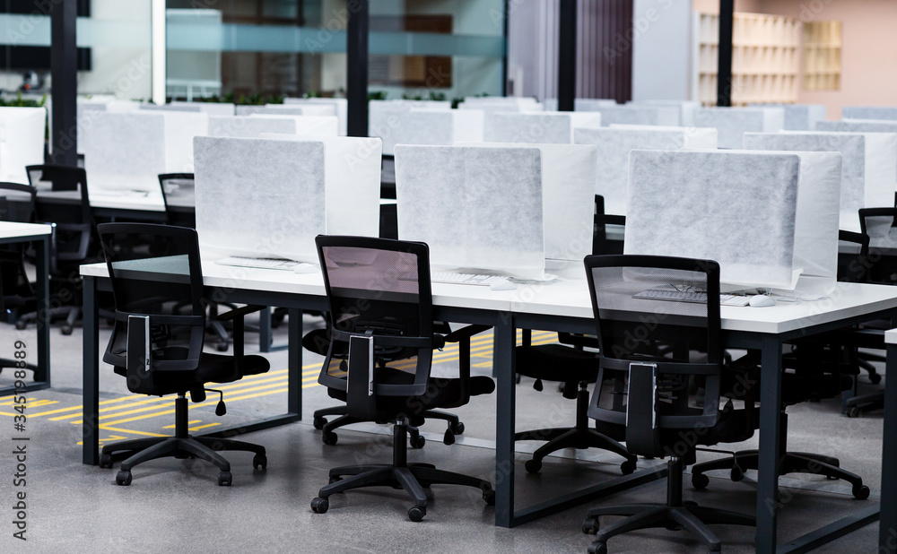 Photo of a computers wrapped in cover, empty coworking Photo of a computers wrapped in cover, empty coworking