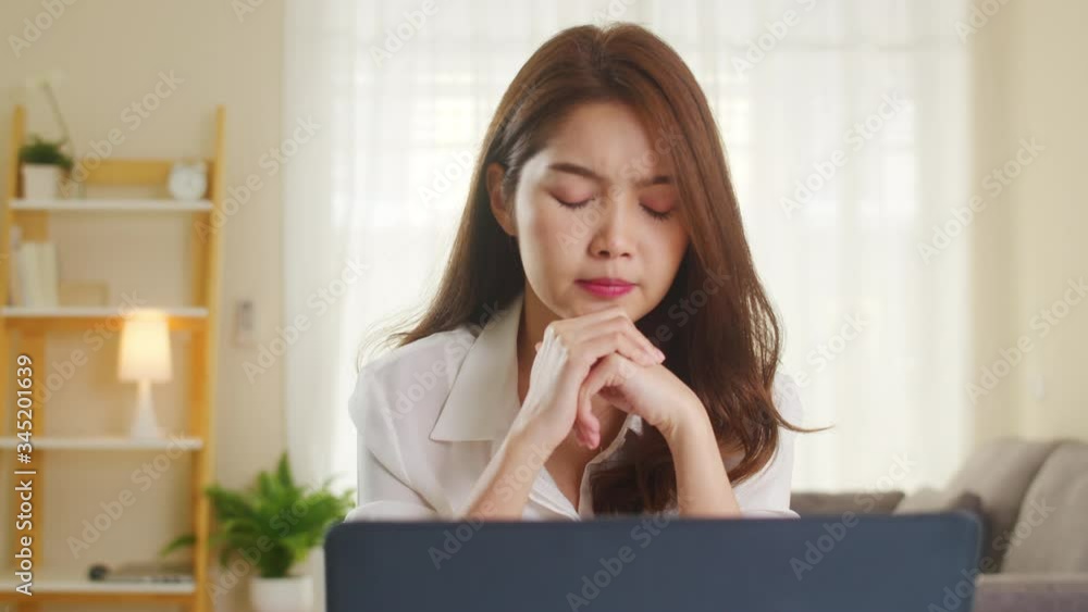 Portrait of freelance Asia women casual wear using laptop hard work in living room at home. Working from home, remotely work, self isolation, social distancing, quarantine for coronavirus prevention. Portrait of freelance Asia women casual wear using laptop hard work in living room at home. Working from home, remotely work, self isolation, social distancing, quarantine for coronavirus prevention.