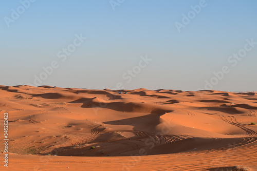 Off-road safari trip at the dunes in the red sand desert in Saudi Arabia. Arabic people making picnics in the desert far away from the city.