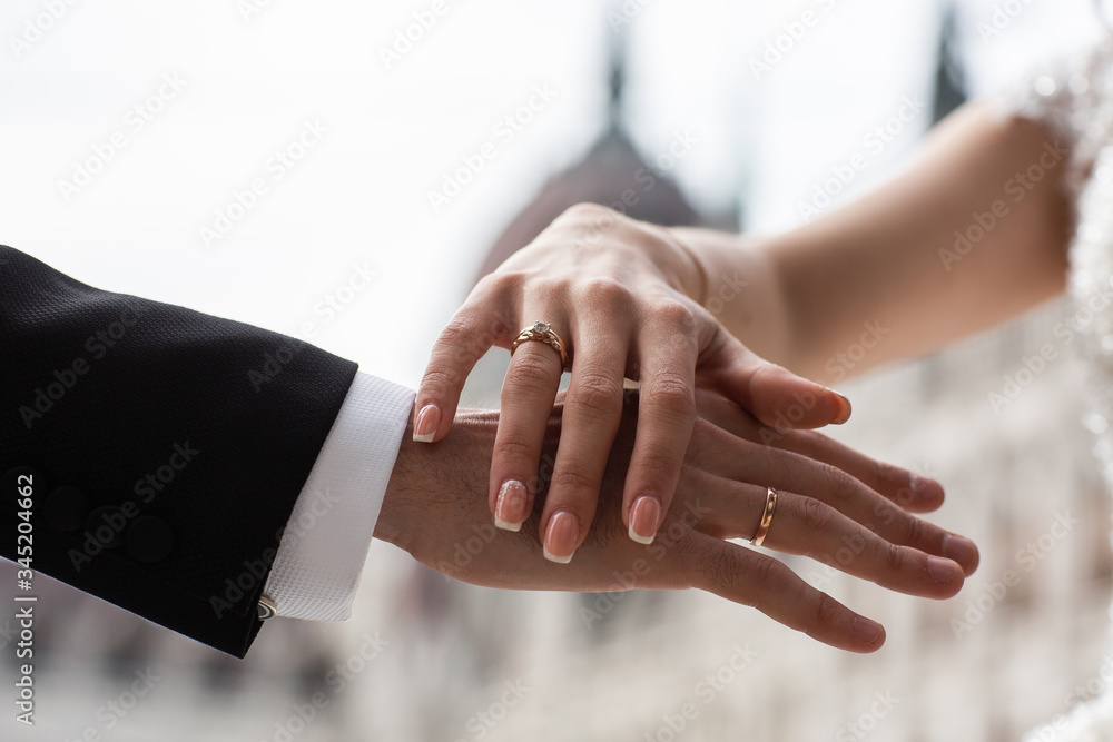 Closeup of loving couple holding hands. Love, Valentine and wedding concept. Just married couple showing rings and love. Top view. Advertising for jewelry salon. Wedding banner. horizontal Closeup of loving couple holding hands. Love, Valentine and wedding concept. Just married couple showing rings and love. Top view. Advertising for jewelry salon. Wedding banner. horizontal
