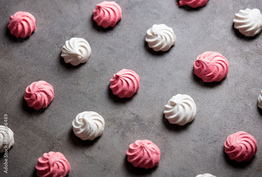 pink and white meringues on a gray background pink and white meringues on a gray background