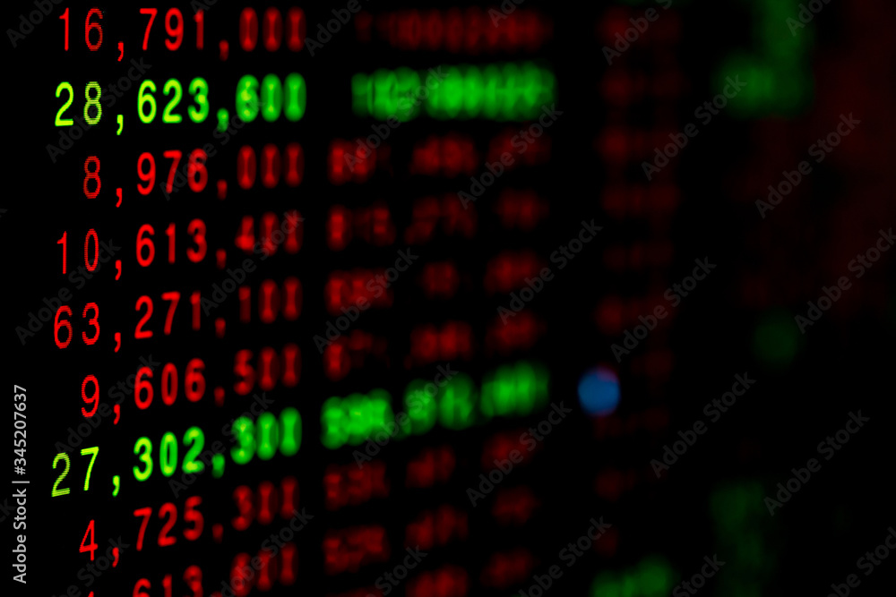 Stock exchange market business concept with selective focus effect. Display of Stock market quotes. Red and green numbers on the electronic board.