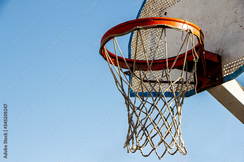 Vintage basketball ring with a blue sky background. Selective Focus.