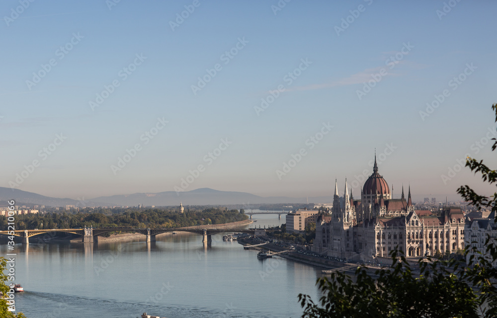 Hungarian Parliament building in the city of Budapest. Budapest at sunrise with clear blue sky. A sample of neo-gothic architecture, Budapest tourist attraction