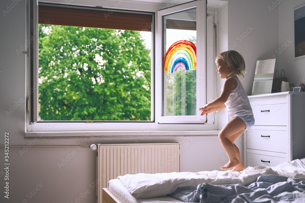 Cute little girl having fun time jumping on bed at home. - obrazy, fototapety, plakaty 