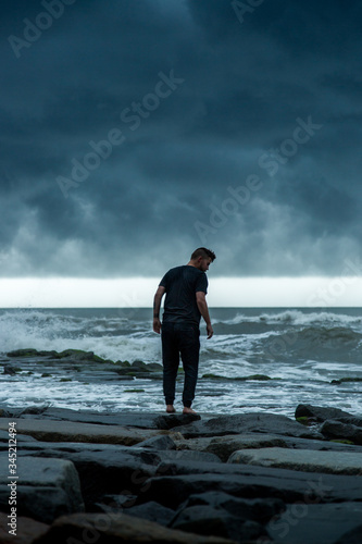 man walking on stormy coast © Luke
