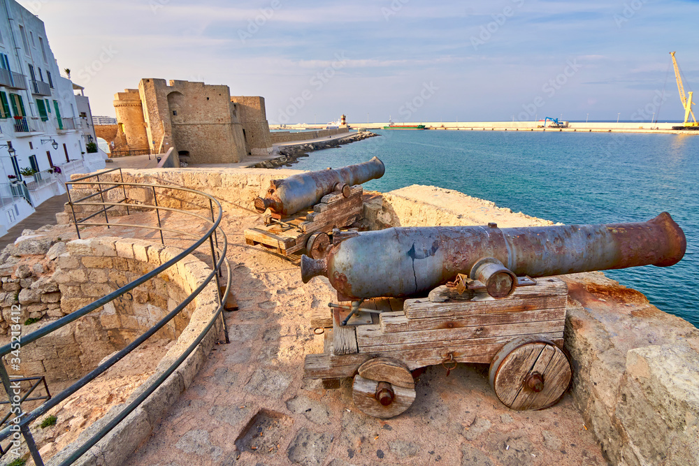 Two Medieval Defense Cannons and Turret In Front Of Castle Carlo V in beautiful Monopoli - Apulia - Puglia - Italy