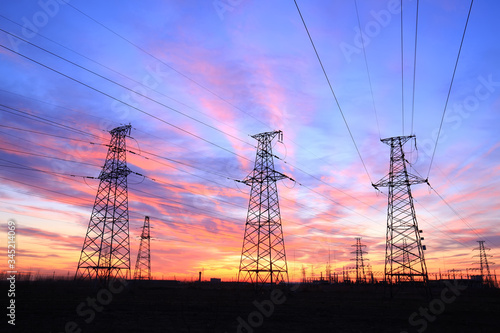 In the evening, the high voltage tower and the beautiful sunset glow