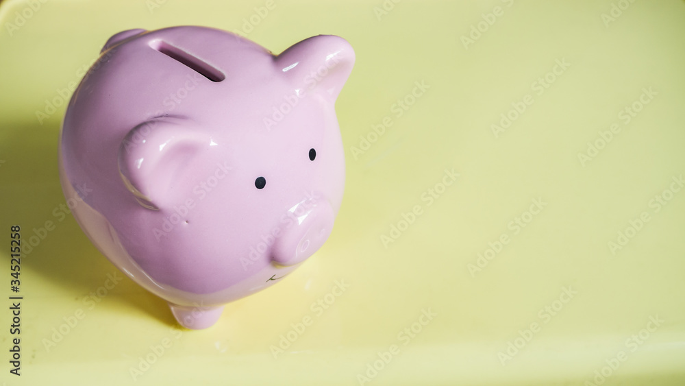 piggy bank is isolated in yellow background. saving money is an investment for the future. piggy bank is isolated in yellow background. saving money is an investment for the future.