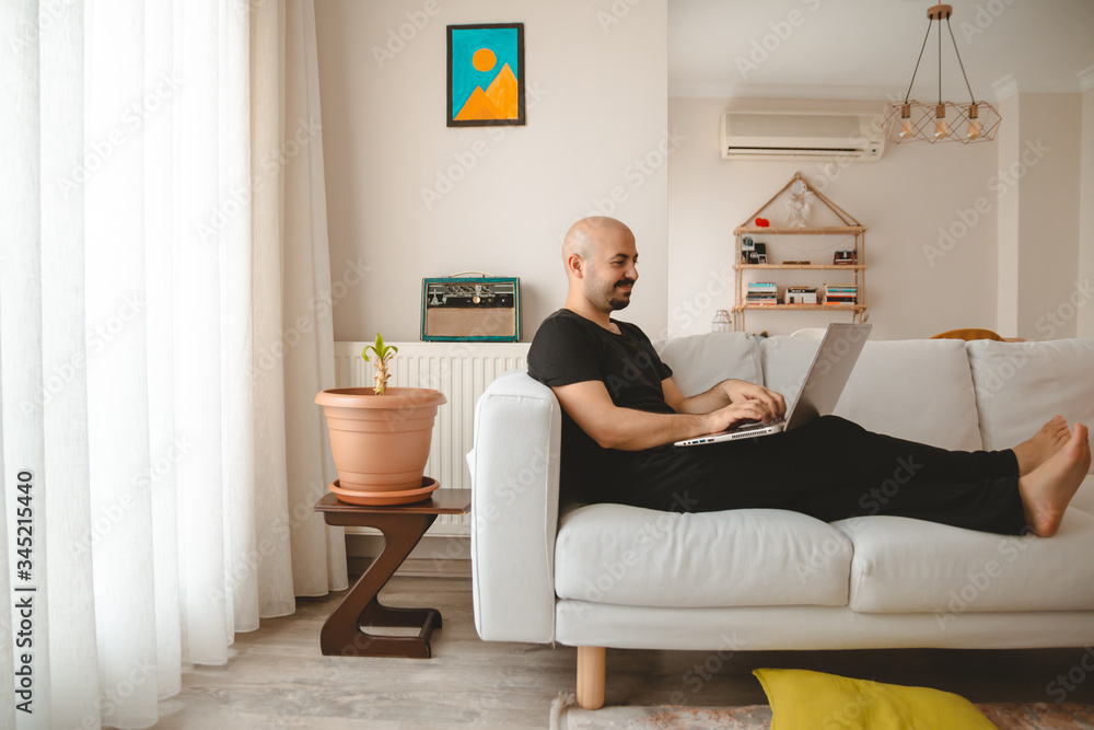 young man using laptop and sitting on the floor on the floor young man using laptop and sitting on the floor on the floor