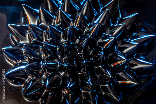 Closeup of magnetized ferro-fluid, colorful, abstract, geometric pattern of liquid metal 