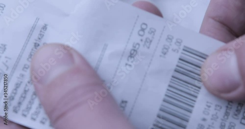 Finances during a COVID-19 crisis. Checking a long grocery receipt