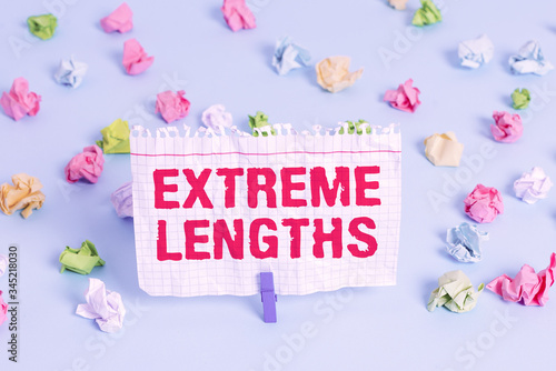 Text sign showing Extreme Lengths. Business photo showcasing Make a great or extreme effort to do something better Colored crumpled papers empty reminder blue floor background clothespin photo