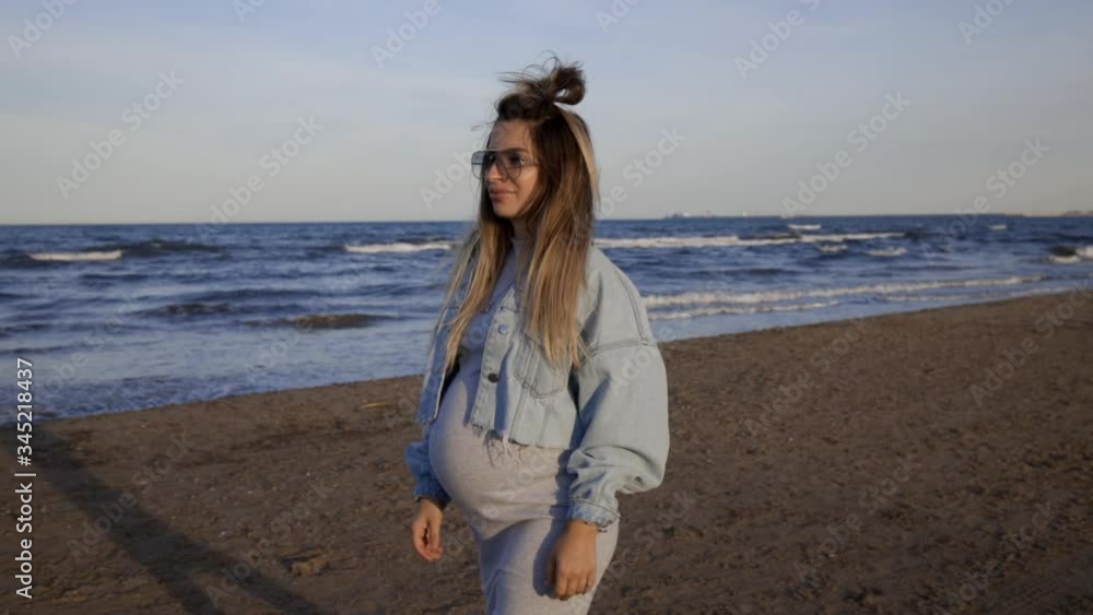 pregnant girl walking around shoreline in sunny day and good weather pregnant girl walking around shoreline in sunny day and good weather