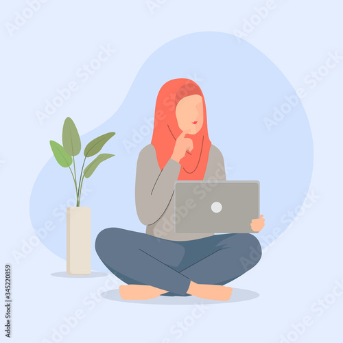 Moslem women using laptop sitting on the floor serious face thinking about question,