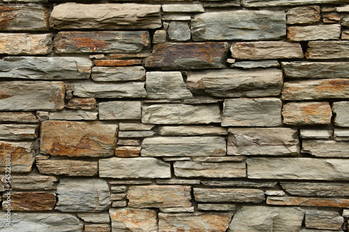 Natural background pattern, Otago schist stone wall, rugged grunge stone texture. photo