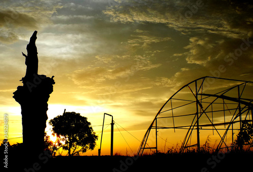 Bhagalpur, India- Aug 14, 2018: A landscape Silhouette view of wood and steel structure with Background of beautiful sunset orange cloud and open sky which makes a beautiful awesome scenery texture.