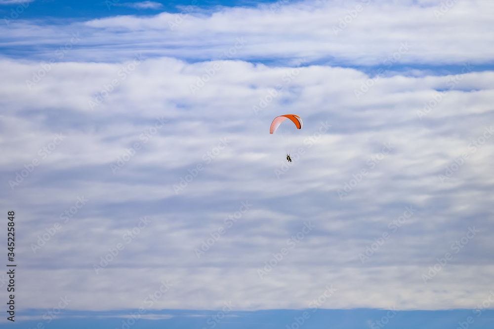 Paraglider flies high in the sky in beautiful clouds Paraglider flies high in the sky in beautiful clouds