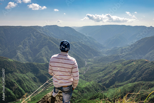 man watching the beautiful mountain range from edge of mountain