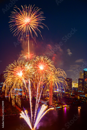 Beautiful firework display for celebration happy new year and merry christmas with  Twilight night and firework lighting in bangkok cityscape background, Thailand. © lukyeee_nuttawut