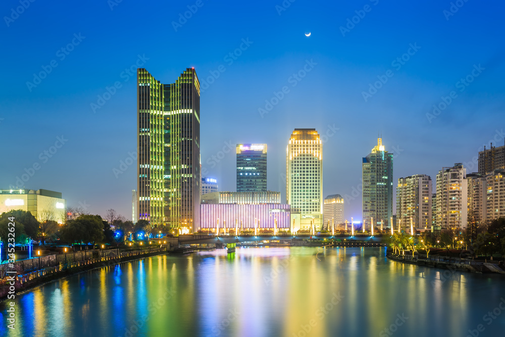 Naklejka premium Night view of Hangzhou canal building..