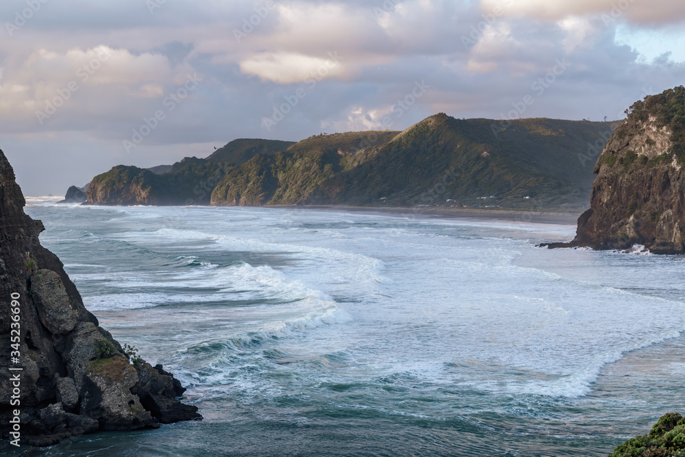 Aerial view of large waves approaching Piha beach 