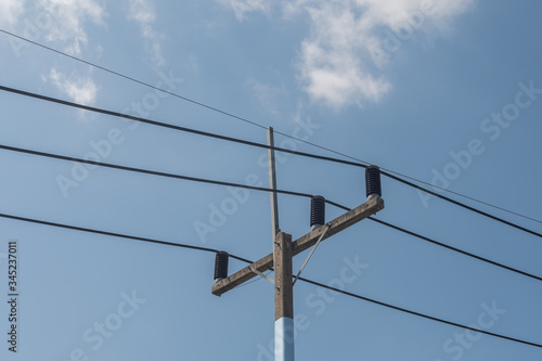 Wallpaper Mural Power lines strung onto to coiled transformers against and blue sky.  Torontodigital.ca