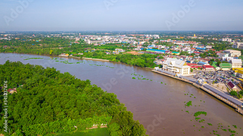 Aerial view of community, temple and building along the Bang Pakong river in Chachoengsao province, Thailand.