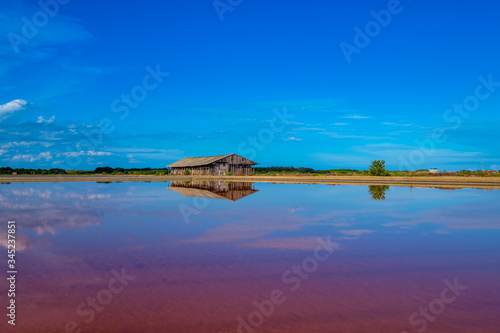 Salt barn with blue sky background in salt fields at Bang Tabun city of Petchaburi province, Thailand