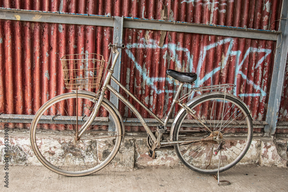 old bicycle in front of a wall