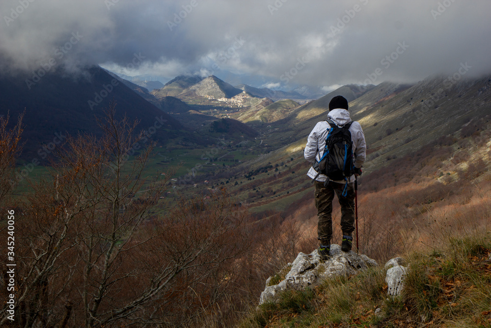 hiker on the top of a mountain letino valley