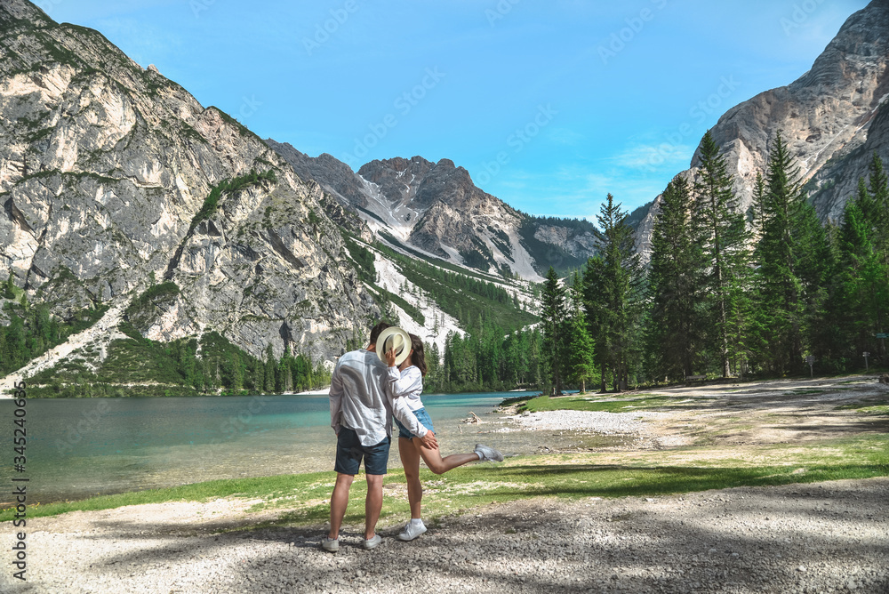 couple kissing at summer lake in mountains