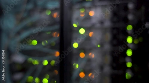 Colorful bokeh with blinking multicolored neon lights server room.