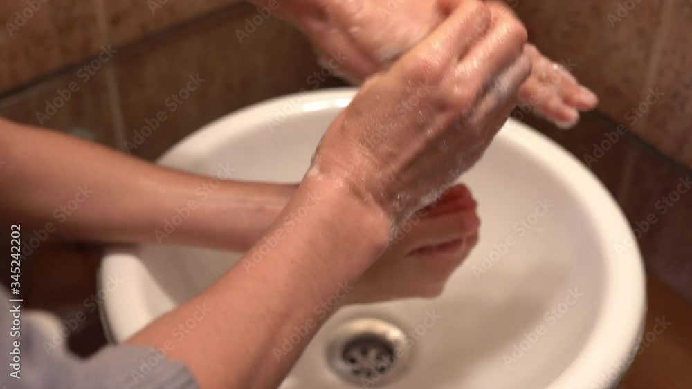 Mother washing her daughter's hands as a Coronavirus pandemic prevention Mother washing her daughter's hands as a Coronavirus pandemic prevention