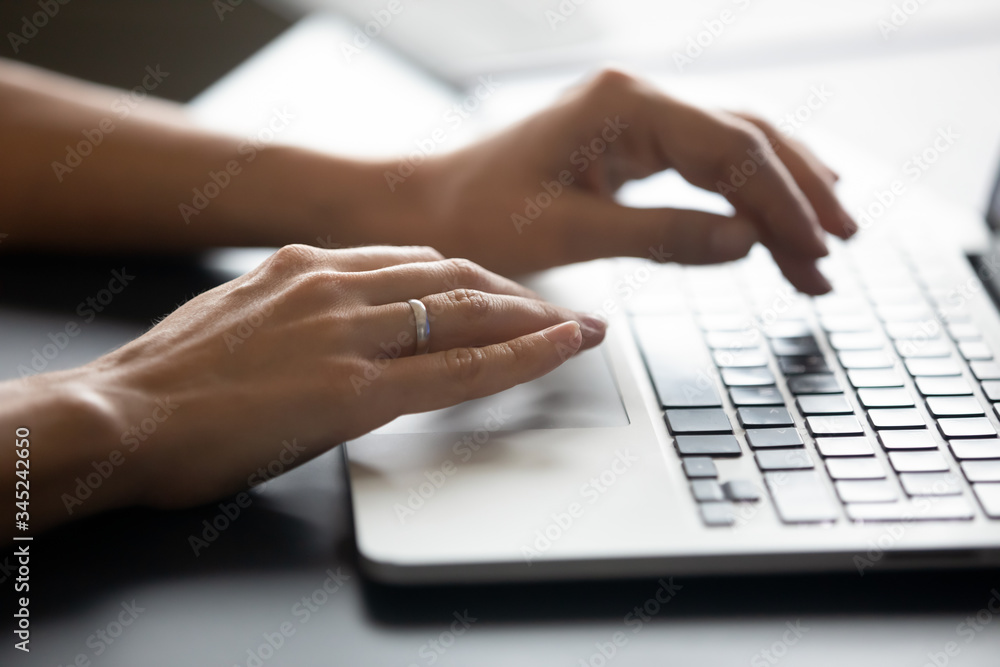 Close up female hands typing on laptop keyboard, woman blogger working online, writing financial report, blog or email, chatting with friends in social network, using computer apps Close up female hands typing on laptop keyboard, woman blogger working online, writing financial report, blog or email, chatting with friends in social network, using computer apps