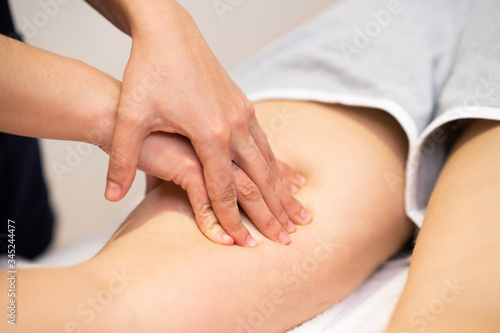 Medical massage at the leg in a physiotherapy center.