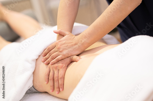 Young woman receiving a back massage in a physiotherapy center