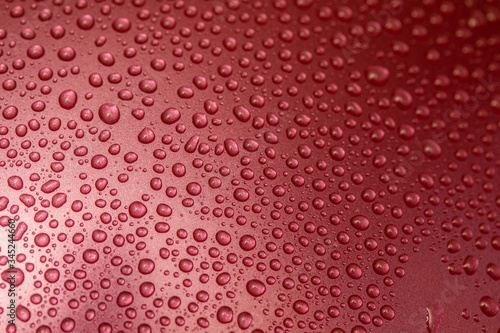 Raindrops on a glass background, red raspberries. Texture of a drop of water on glass.