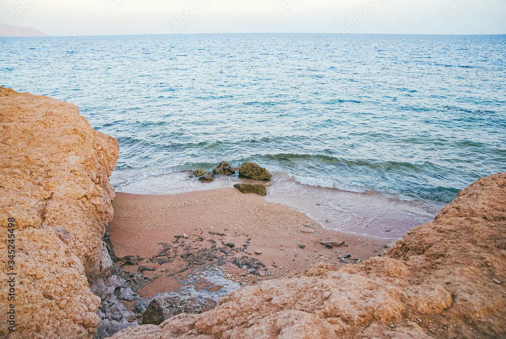 rocky sea shore lit by the bright spring sun. Deserted meditative landscape rocky sea shore lit by the bright spring sun. Deserted meditative landscape