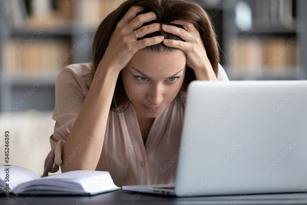 Stressed unhappy woman looking at laptop screen close up, touching head, feeling exhausted, tired young female student or freelancer working on computer, having headache or problem with work Stressed unhappy woman looking at laptop screen close up, touching head, feeling exhausted, tired young female student or freelancer working on computer, having headache or problem with work