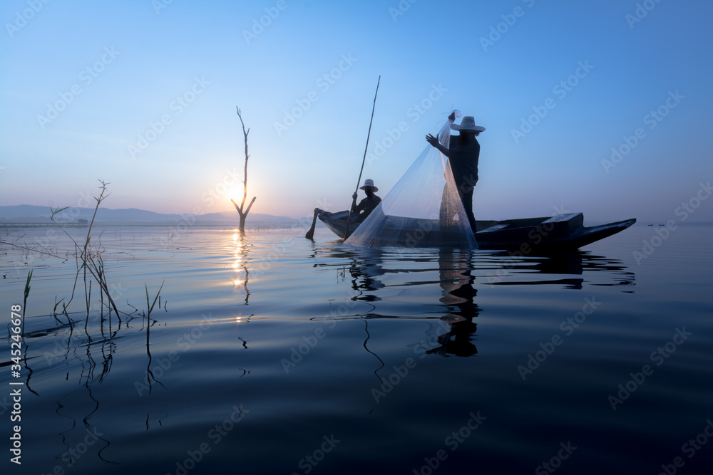 Naklejka premium fisherman asia silhouette morning sun rise