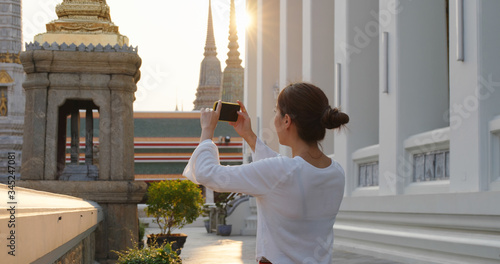 Canvas Print Woman go travel and take photo on cellphone at bangkok